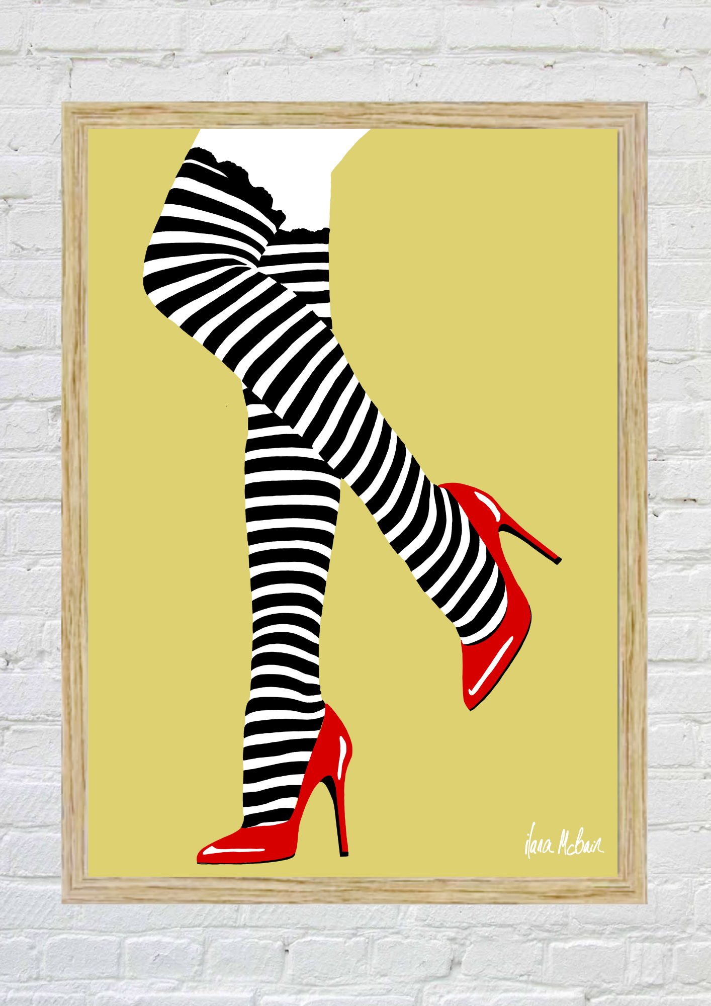 Framed artwork of black and white striped stockings with red high heels on a yellow background.