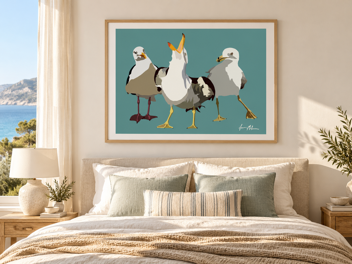 Beach Gossip contemporary seagull art print displayed above a bed in a bright coastal bedroom with natural timber, soft linen and muted blue accents.