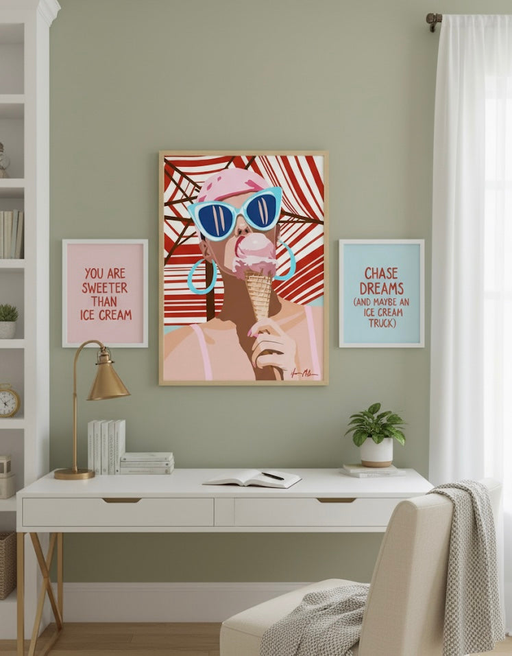 Fine art print of a girl wearing retro sunglasses and eating an ice cream cone against a striped beach umbrella background on a cool home office wall.