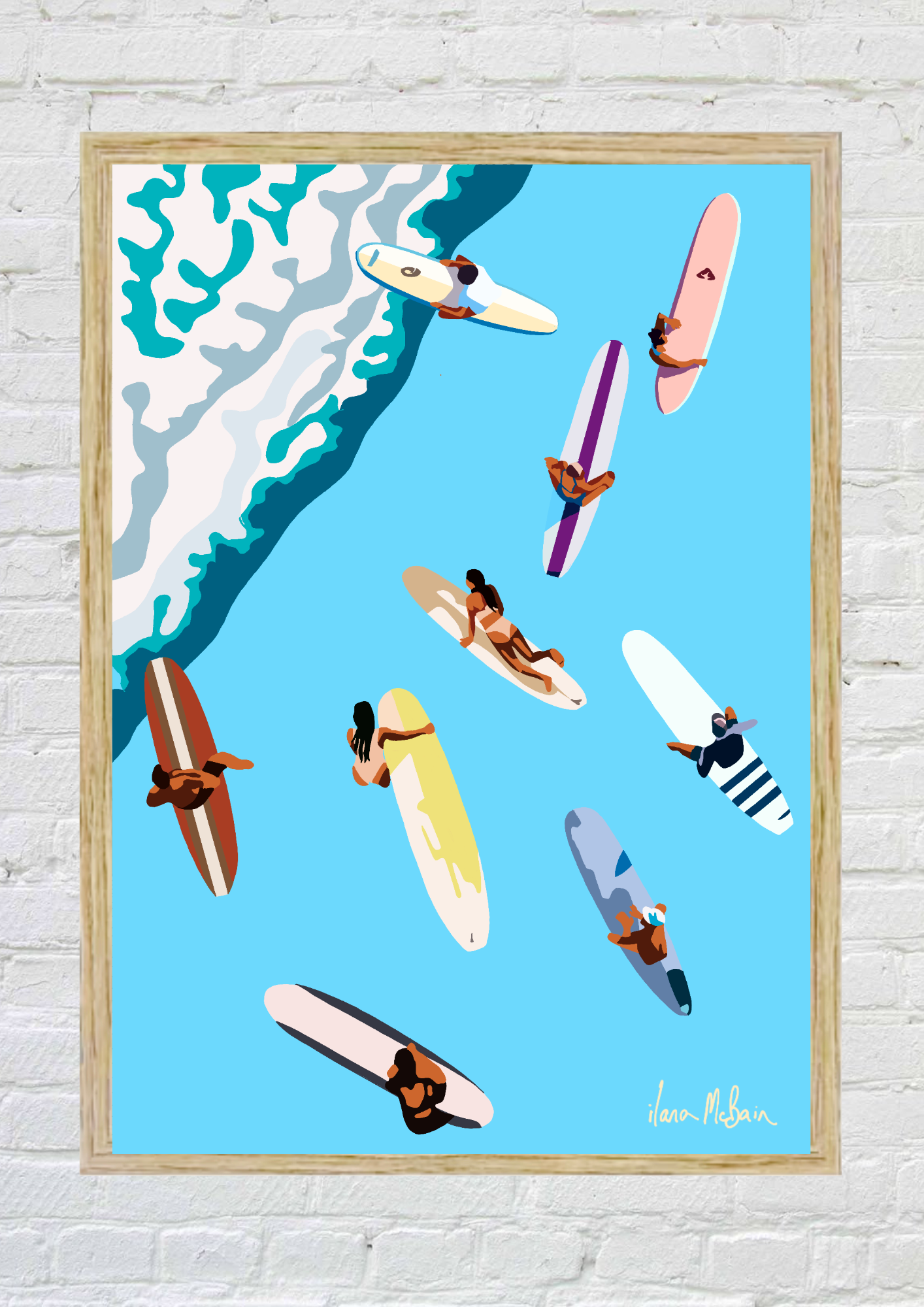 Framed artwork of surfers on surfboards against a blue ocean with a white wave.