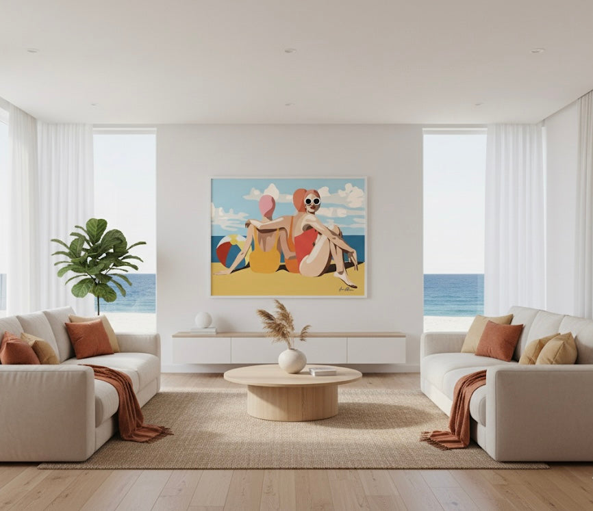 Three women in swimsuits sitting on a beach with a colourful ball and blue sky. Retro pop art print. Framed on a coastal house wall.