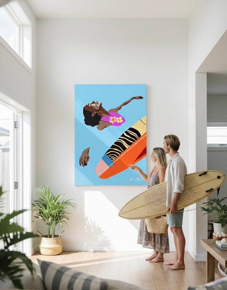 large, colorful painting of a swimmer and surfboard hanging on a white wall in a bright, modern room. Two people stand in front of the art; a woman points at the painting while a man stands beside her holding a real surfboard.