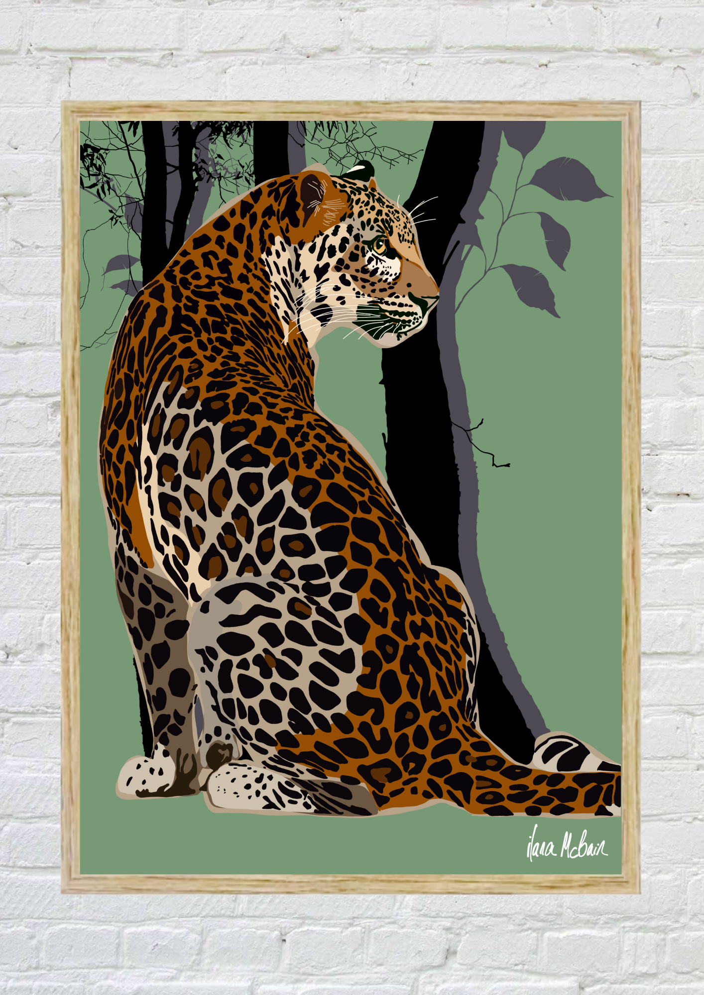 Framed artwork of a leopard in a natural setting on a white brick wall.