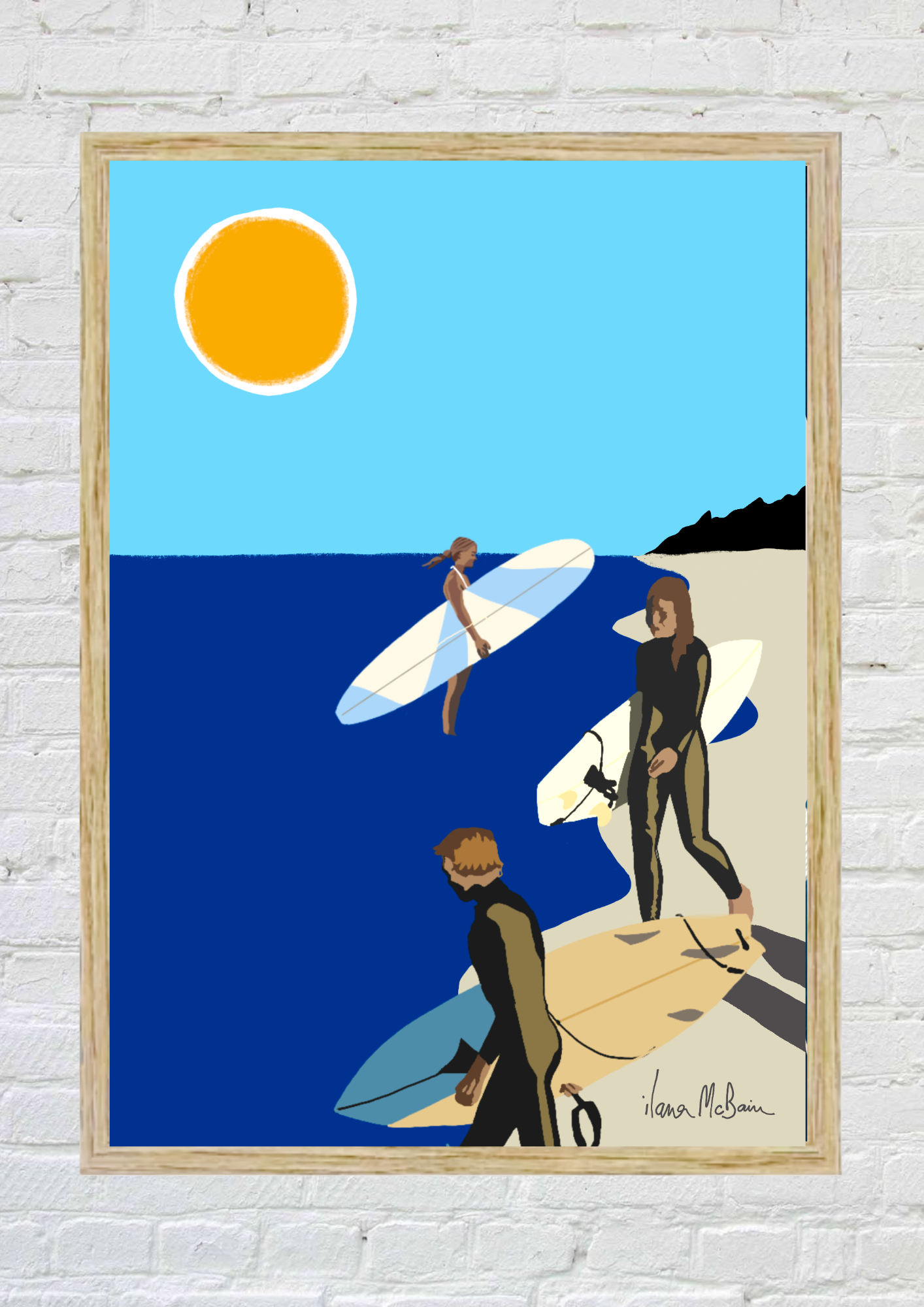 Framed artwork of surfers with surfboards against a blue sky and ocean.