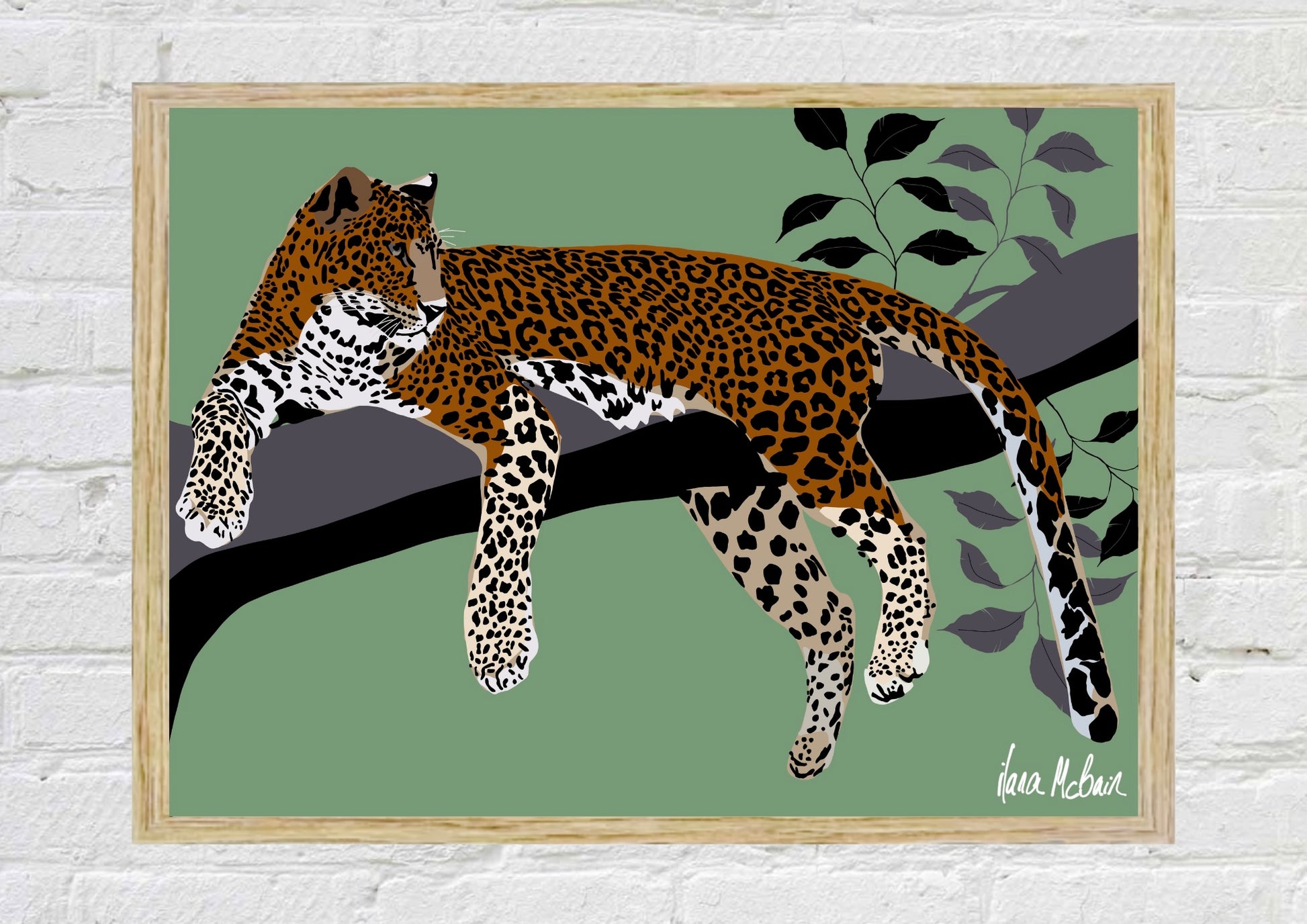 Framed artwork of a leopard on a branch with leaves against a green background
