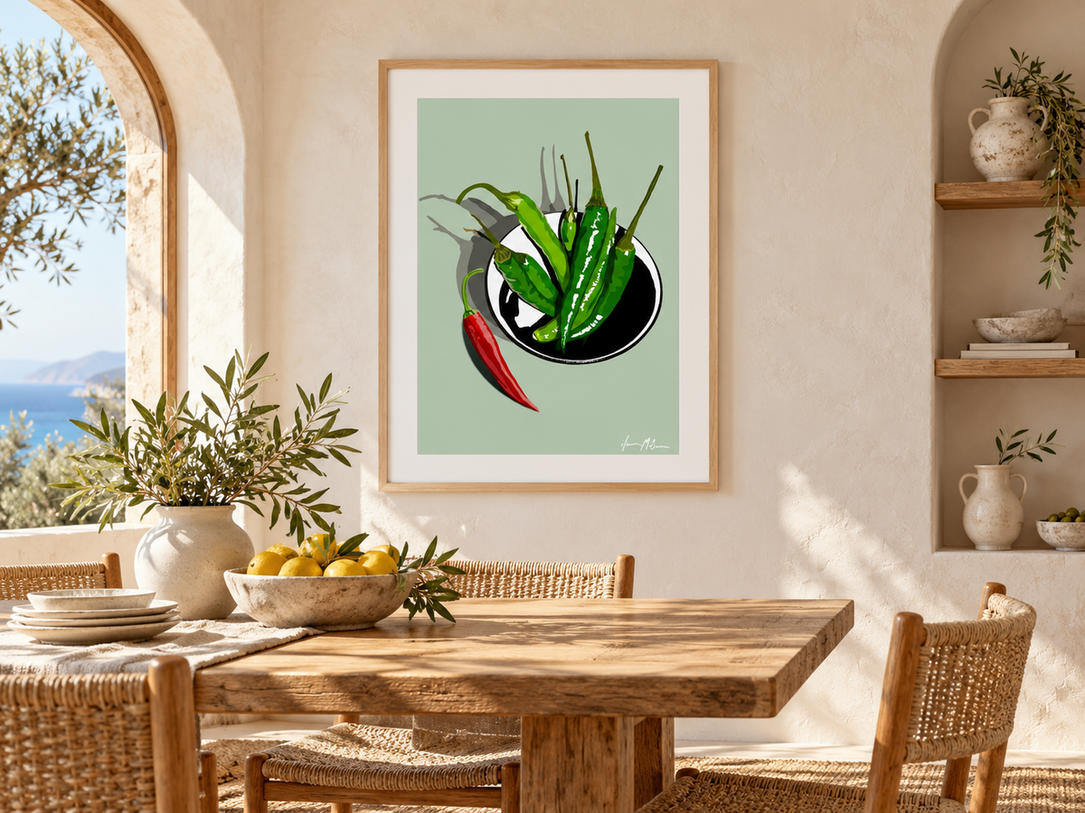 A Little Heat Sage chilli art print displayed in a sunlit Mediterranean-style dining room with natural timber furniture and warm neutral finishes.