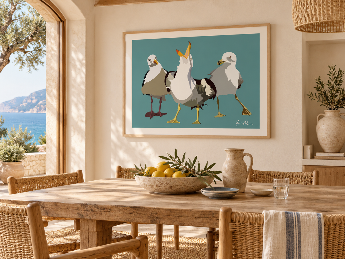 Beach Gossip contemporary seagull art print displayed in a sunlit coastal dining room with natural timber, woven chairs and warm Mediterranean-inspired styling.