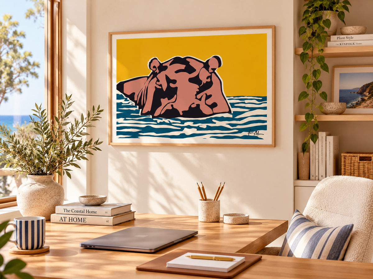Boss of the River contemporary hippo art print by Ilana McBain displayed in a bright coastal home office with light timber desk, neutral furnishings and natural daylight.