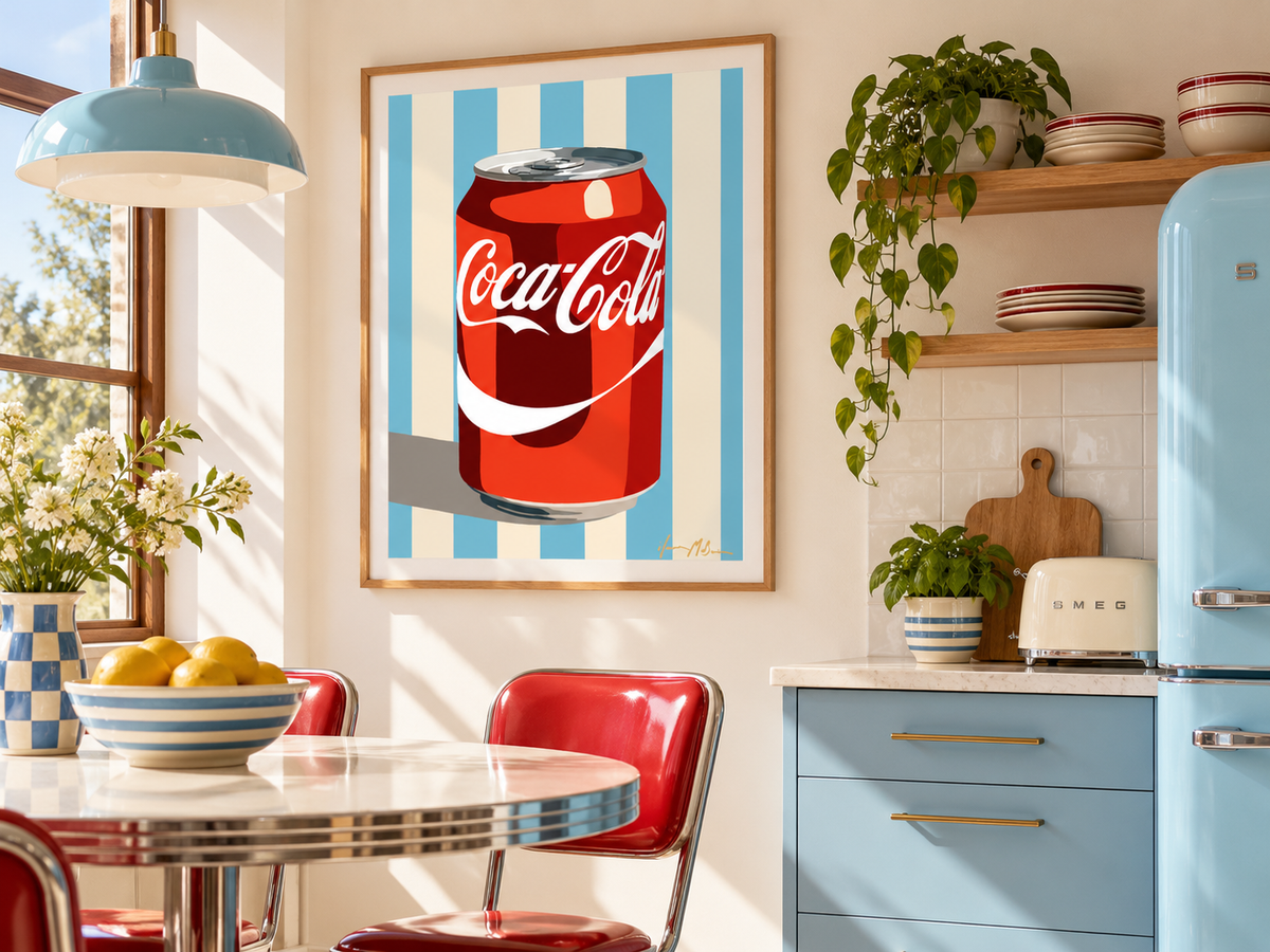 Classic Fizz blue and cream retro cola pop art print by Ilana McBain displayed in a bright retro kitchen with sky blue cabinetry, red chairs and warm timber details.
