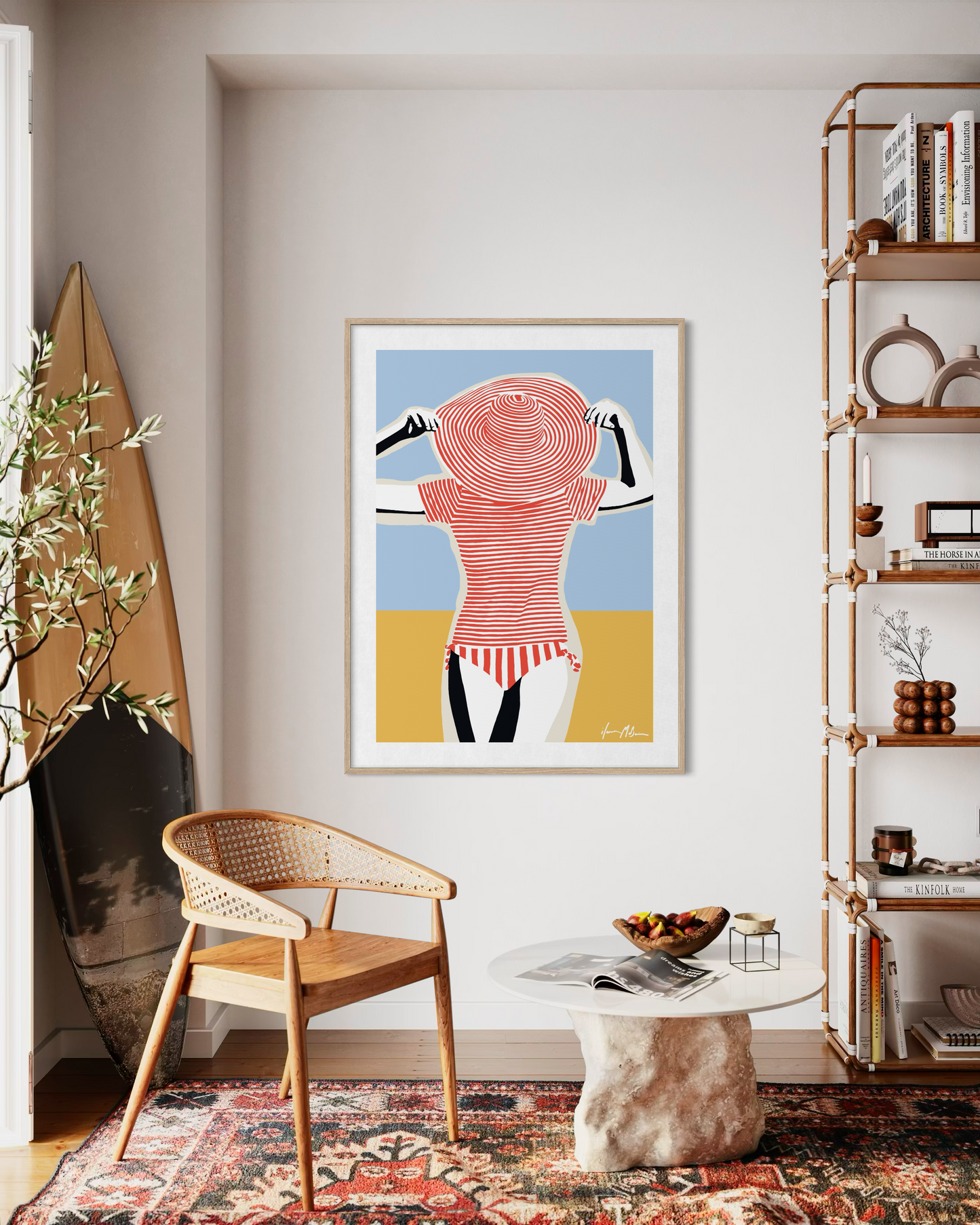 Interior mockup showing a beach-inspired contemporary artwork by Ilana McBain displayed in a coastal style living room with natural wood and surf décor.
