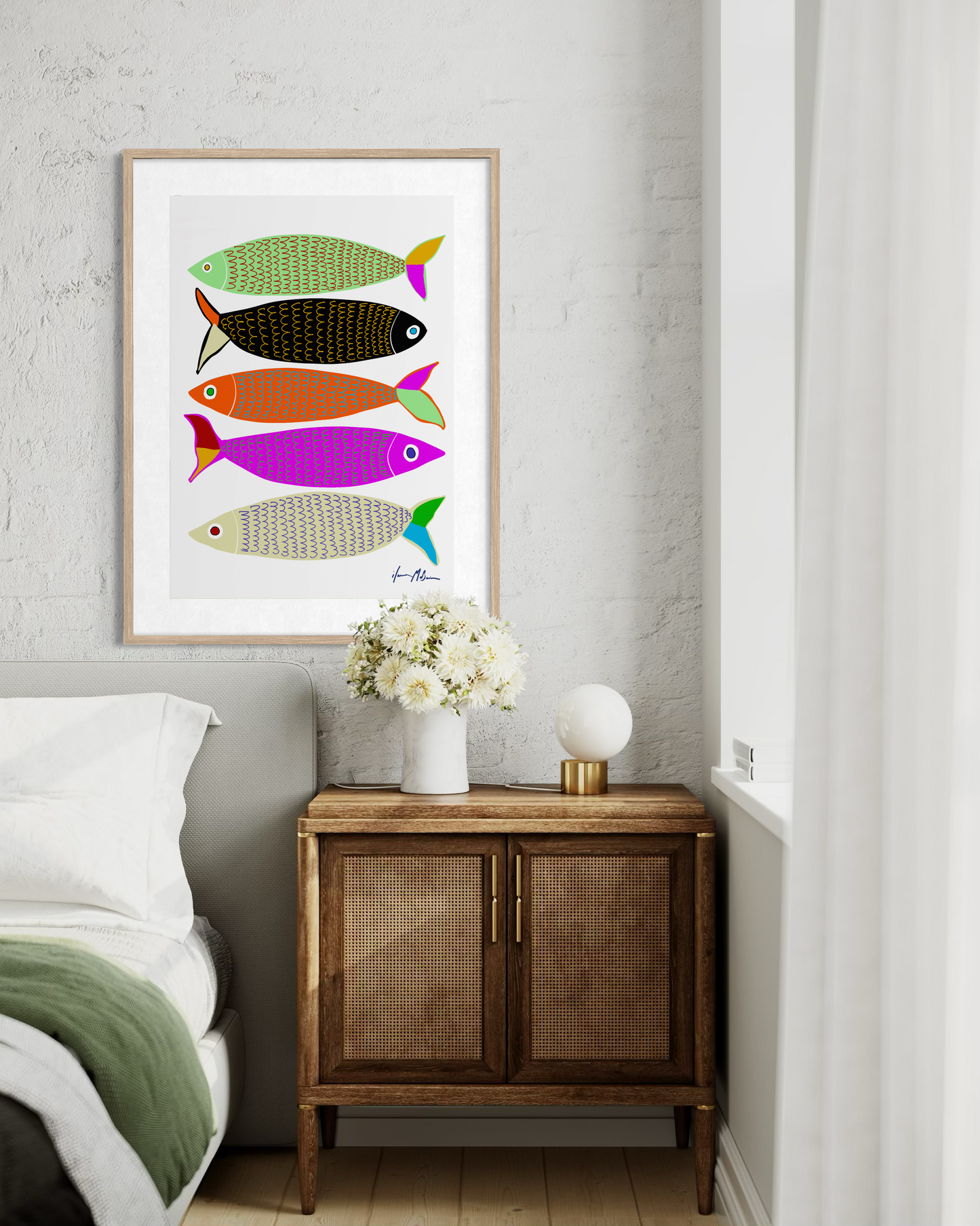 Contemporary colourful fish artwork “Sardines” by Australian artist Ilana McBain displayed as framed pop art wall print in modern bedroom interior.