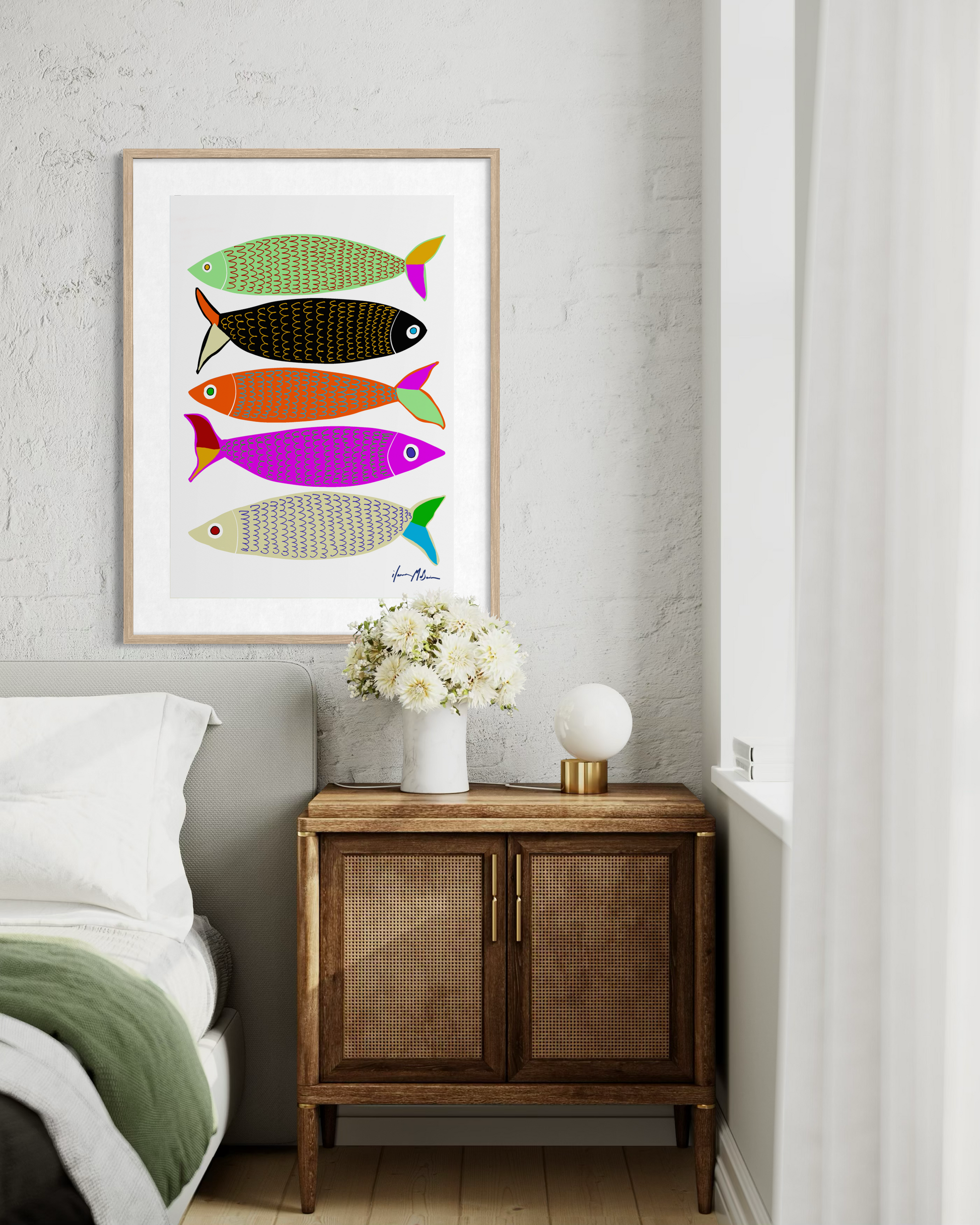 Contemporary colourful fish artwork “Sardines” by Australian artist Ilana McBain displayed as framed pop art wall print in modern bedroom interior.