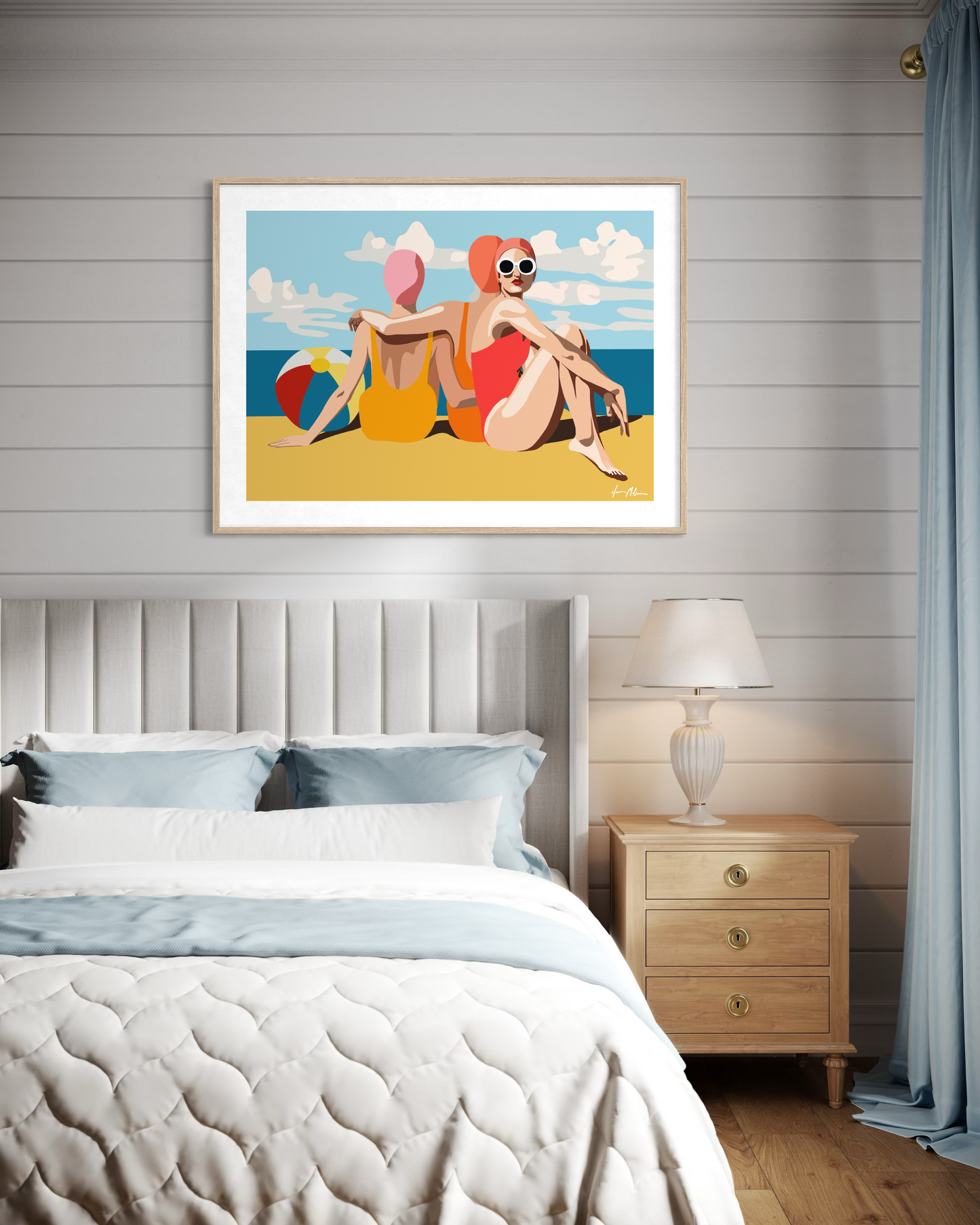 Contemporary summer beach artwork by Australian artist Ilana McBain featuring two women relaxing on the sand beside the ocean displayed above a bed in coastal bedroom interior.