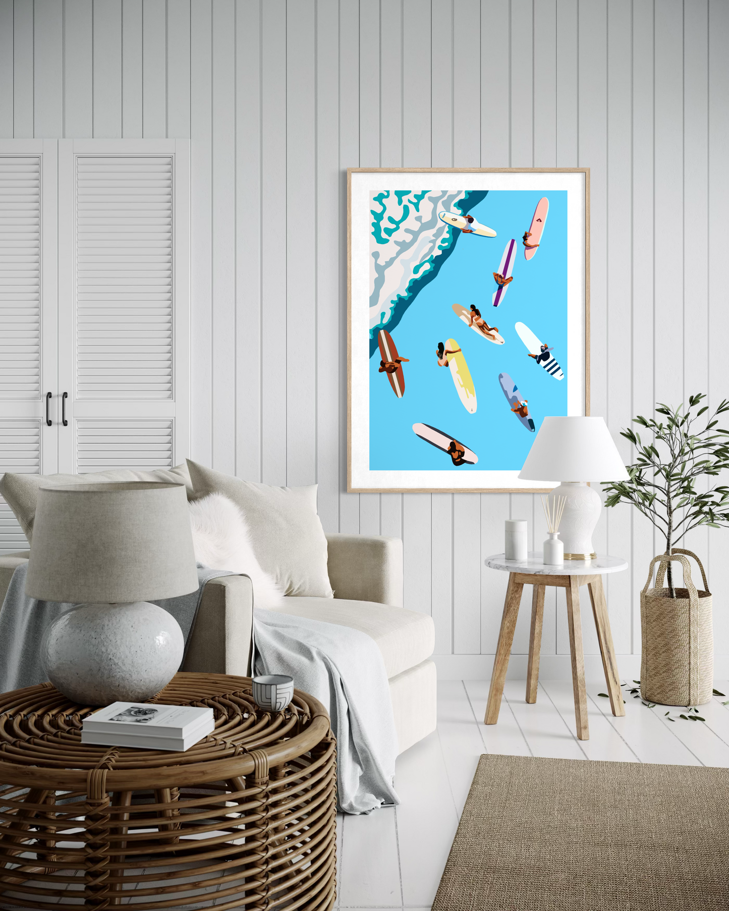Coastal surf artwork by Ilana McBain featuring surfers and surfboards viewed from above displayed as framed beach house wall art in modern living room.