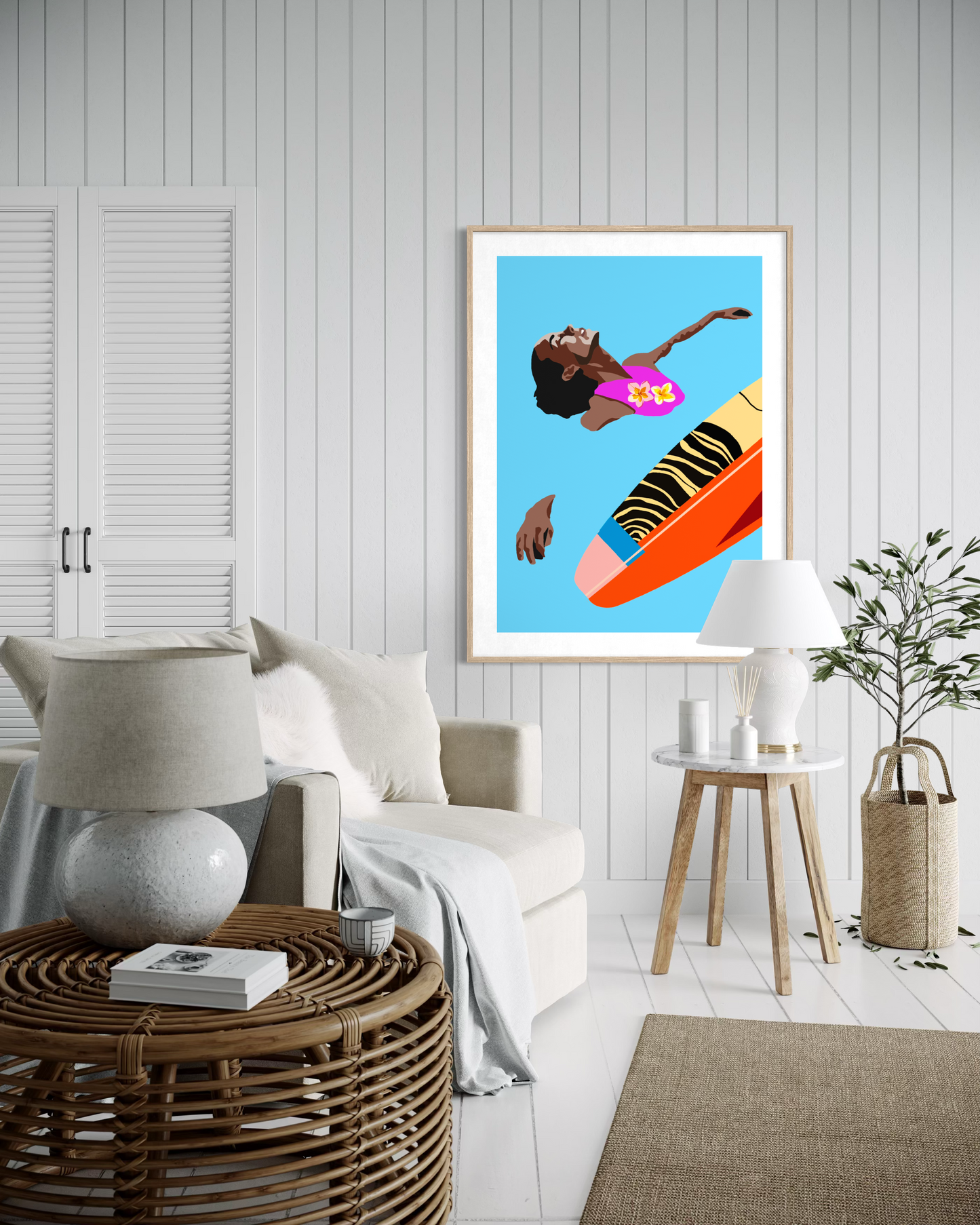 Contemporary tropical surf artwork by Australian artist Ilana McBain featuring a surfer girl floating beside a colourful surfboard displayed as framed coastal wall art.