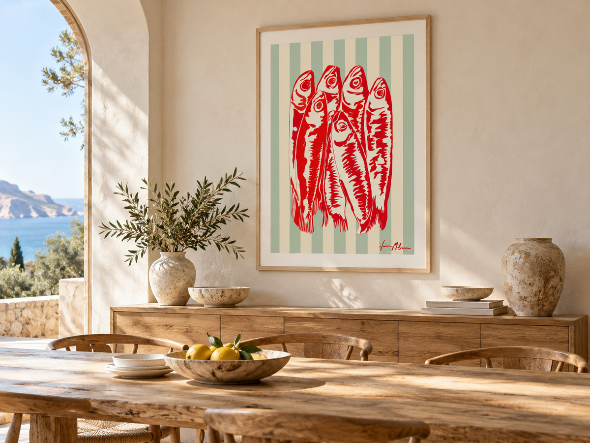 Riviera Sardines art print by Ilana McBain displayed in a sunlit Mediterranean dining room with timber furniture and warm neutral décor.
