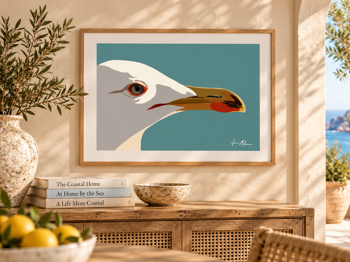 Side Eye contemporary seagull art print displayed above a timber console in a warm coastal interior with natural textures and ocean views.
