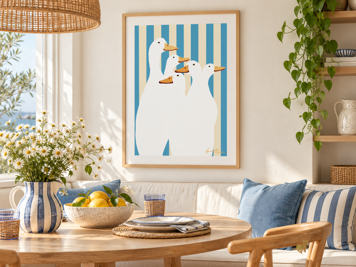 Duck Club blue stripe contemporary duck art print by Ilana McBain displayed in a sunlit coastal dining nook with light timber furniture, blue cushions and natural styling.