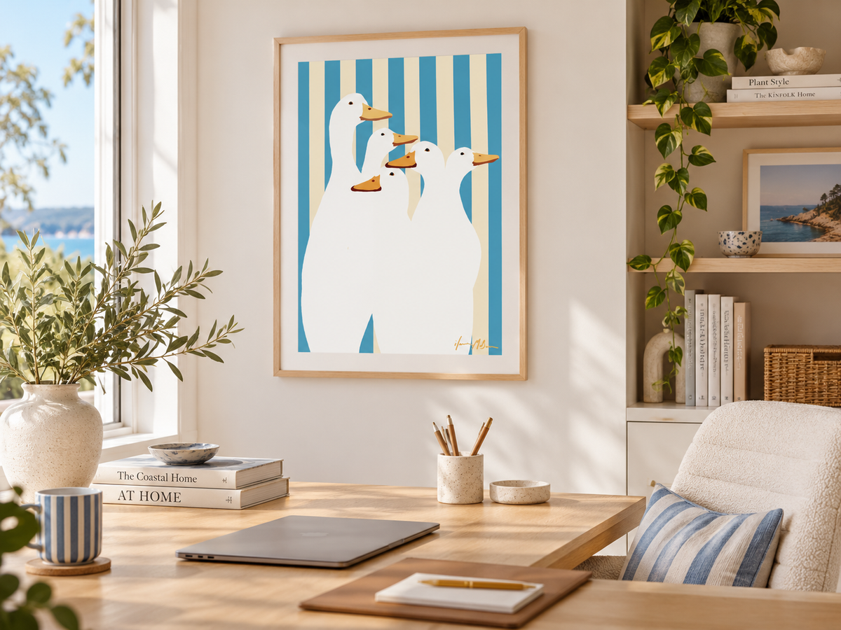 Duck Club blue stripe contemporary duck art print by Ilana McBain displayed in a bright coastal home office with light timber desk, natural textures and blue accents.