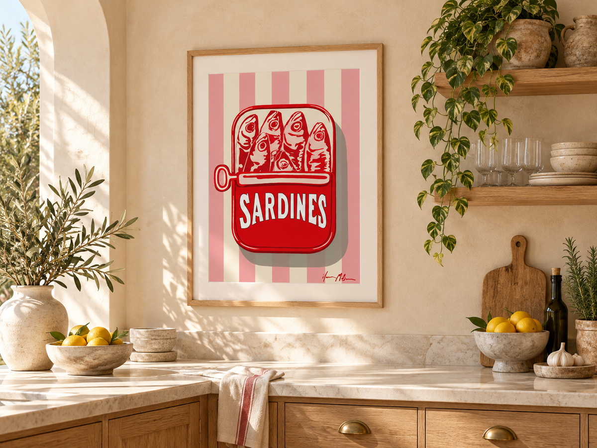 The Sardine Tin pink stripe sardine art print styled in a bright modern kitchen with natural timber cabinetry, stone surfaces and warm Mediterranean-inspired decor.