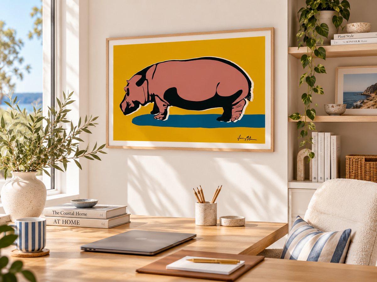Unapologetically Solid hippo art print by Ilana McBain displayed in a bright contemporary home office with light timber desk, natural textures and coastal styling.